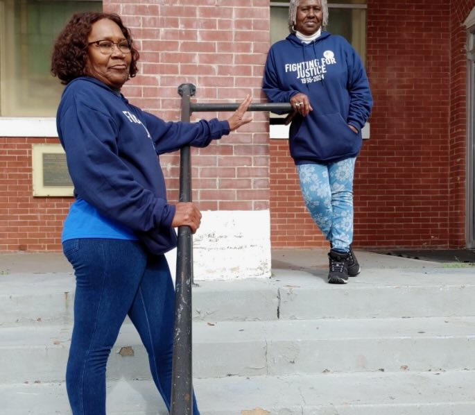 Alice Moore, back right, and Denise Holt, front left, stand on the steps of Brown Chapel.